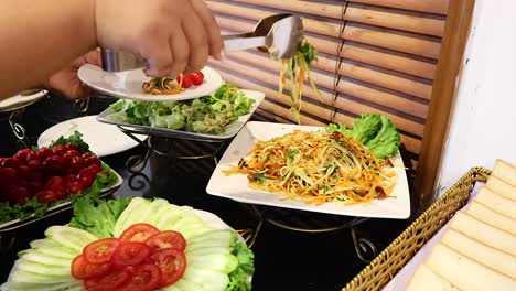 hands preparing a fresh vegetable salad