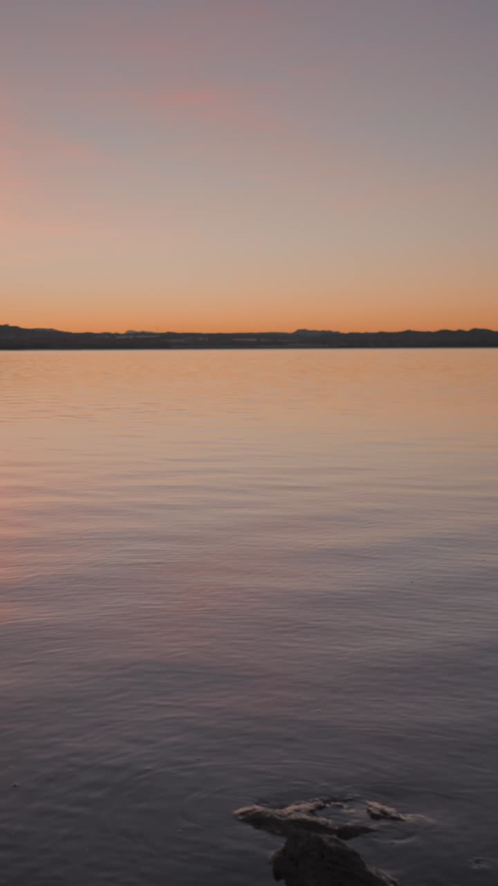 Tranquil Lake at Sunset or Sunrise with Distant Mountains