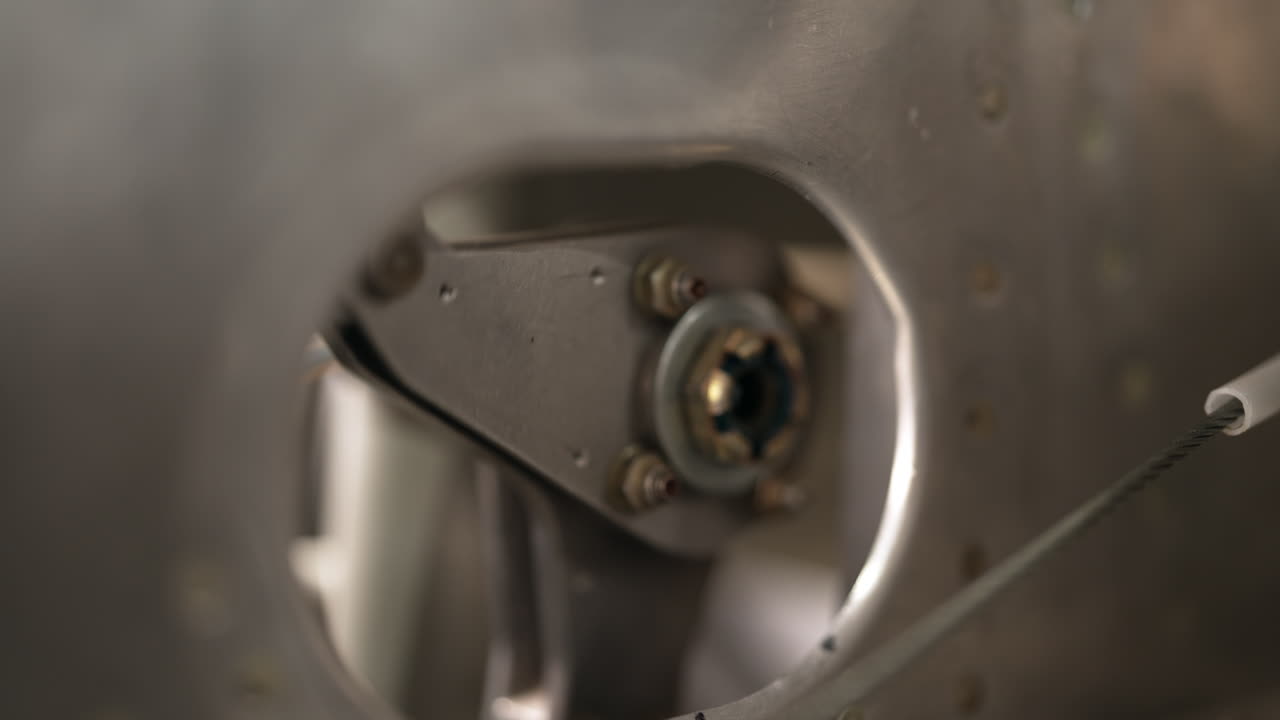 Close up of a metal bearing and fasteners inside an industrial machine, focusing on mechanical precision