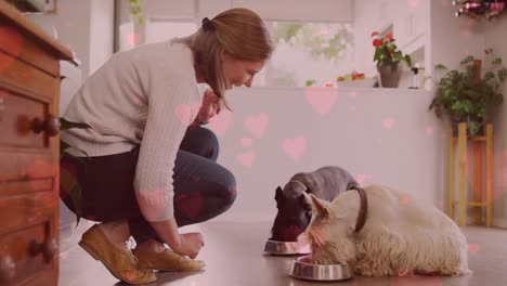 animation of red heart icons over caucasian woman with pet dog