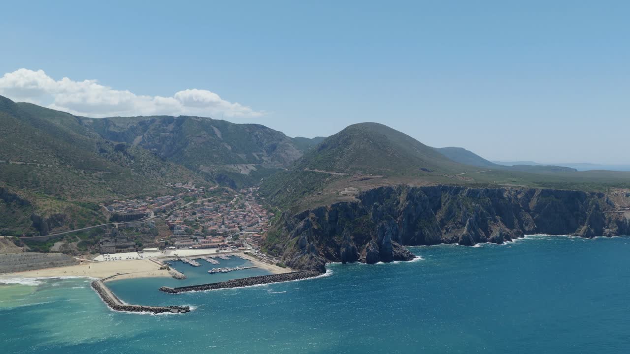 Aerial view of Buggerru, Sardinia, showing rugged coast and blue sea