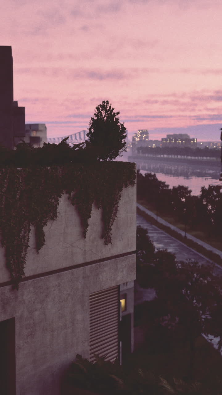 A stunning sunset casts vibrant colors across the sky over an urban riverbank