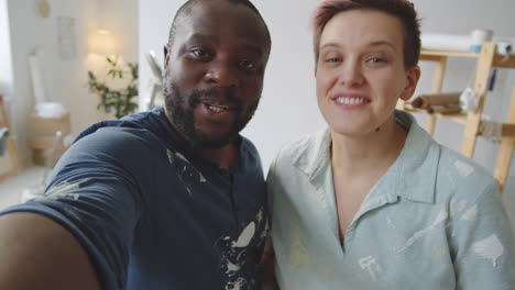 happy couple taking a selfie during home renovation