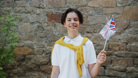 teenager holding british flag