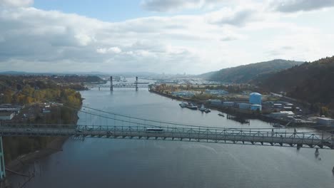 stunning aerial footage of bus driving over a huge bridge called st. johns bridge in portland - the city of bridges in oregon, united states of america