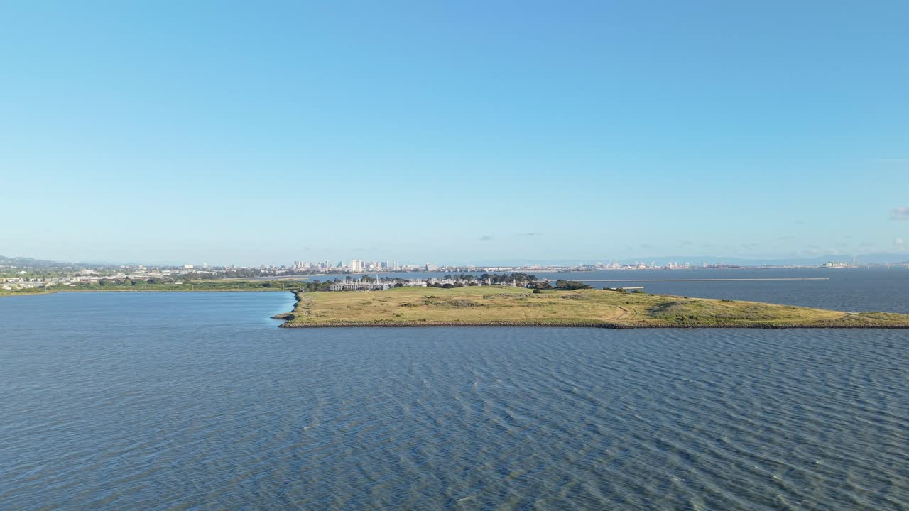 From above, Cesar Chavez Park appears as a natural escape, bordered by calm waves and open sky.