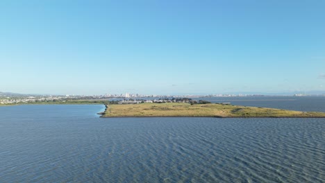 From above, Cesar Chavez Park appears as a natural escape, bordered by calm waves and open sky.