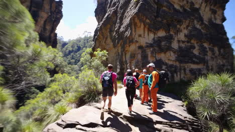 Hikers enjoying a scenic trail through a mountain canyon