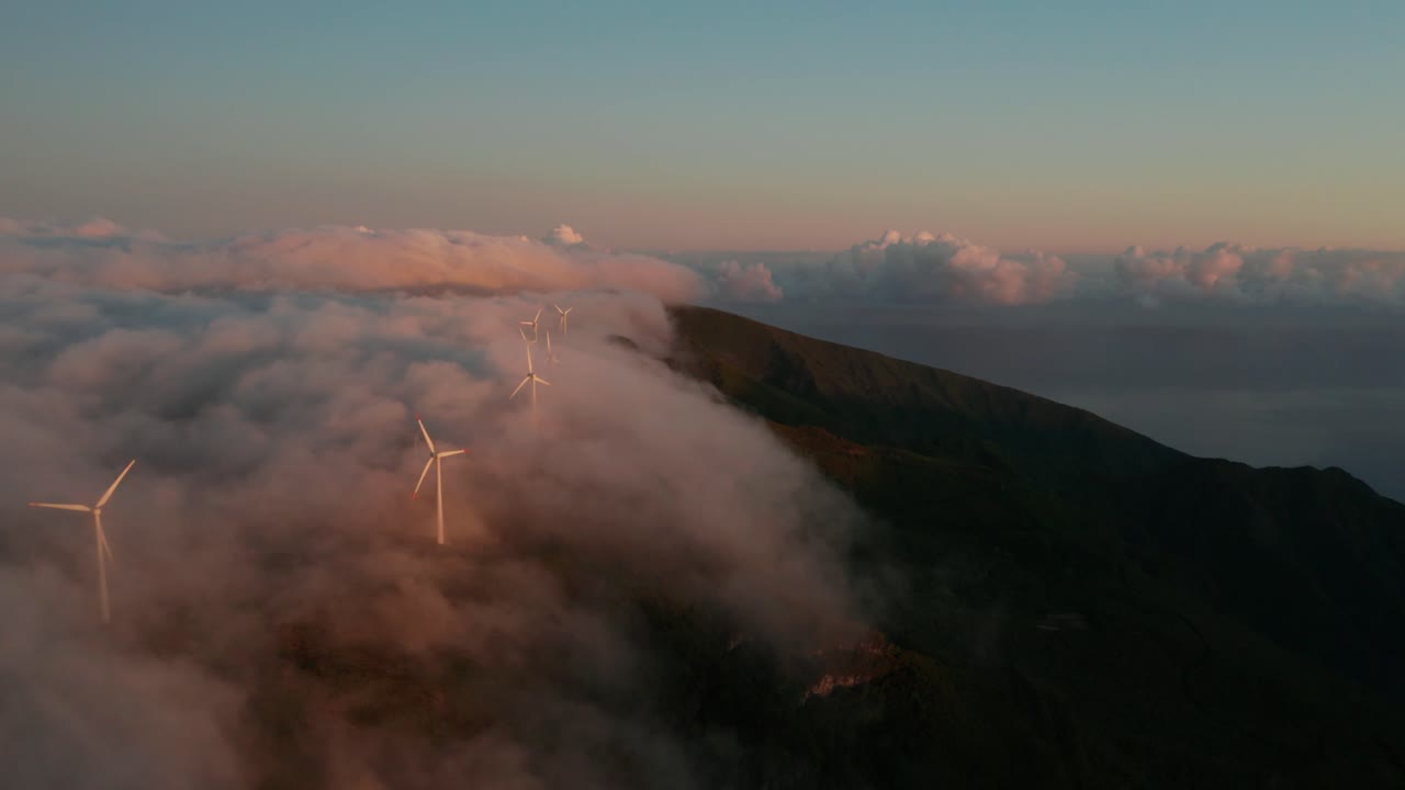 antena del parque montañoso de molinos de viento con una espesa niebla que fluye a través de madeira.
