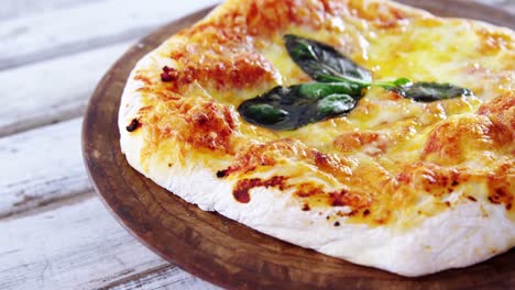 baked pizza on wooden board