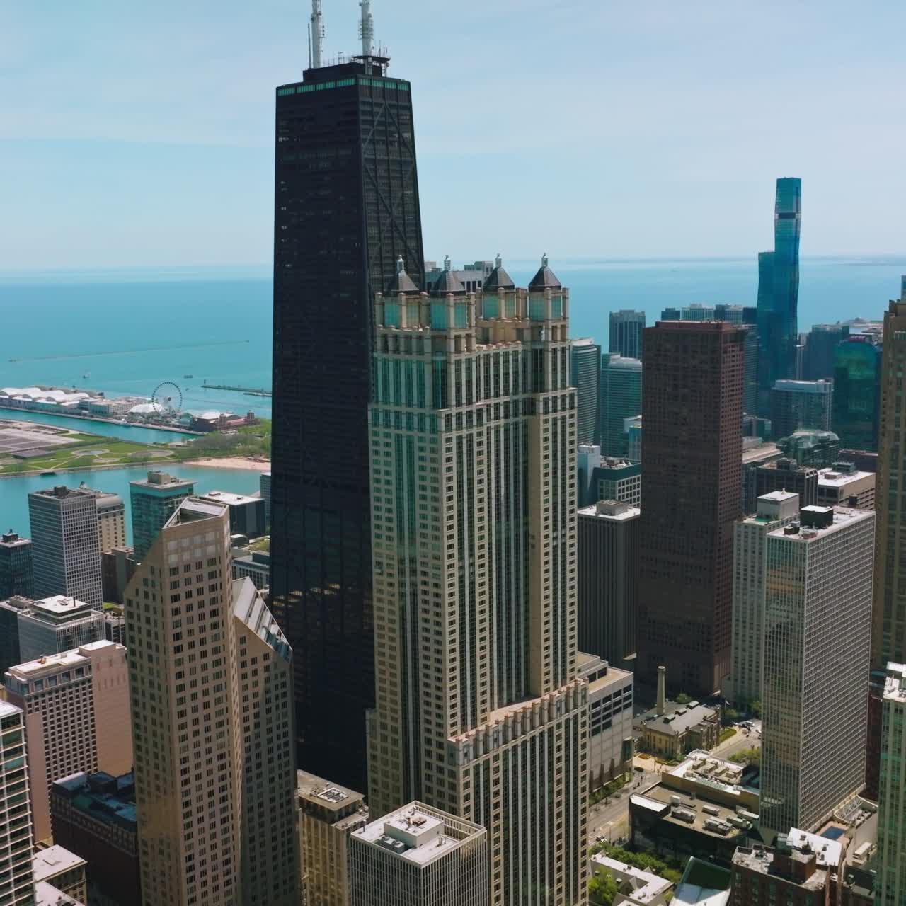 Beautiful skyscrapers of Chicago standing on the waterfront of Lake Michigan. Aerial view of the buildings at the backdrop of blue water and sky
