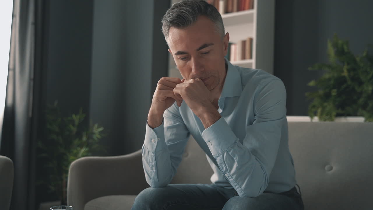 Tired and stressed man. Mature male worried and thinking.