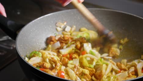 Removing-Glass-Lid-Cover-And-Stir-Chicken-And-Vegetables-Cooking-In-A-Pan