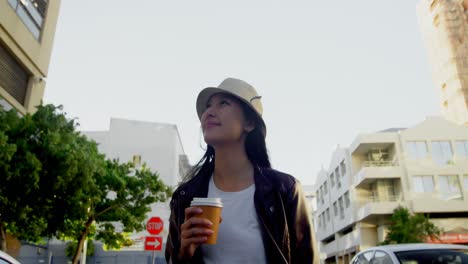 woman having coffee in city street 4k