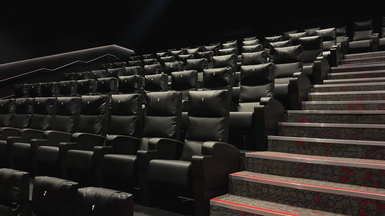 A video of Iași Cinema City at Moldova Mall, showing empty black cushioned seats in a tiered cinema hall