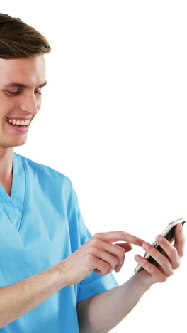 smiling surgeon using mobile phone