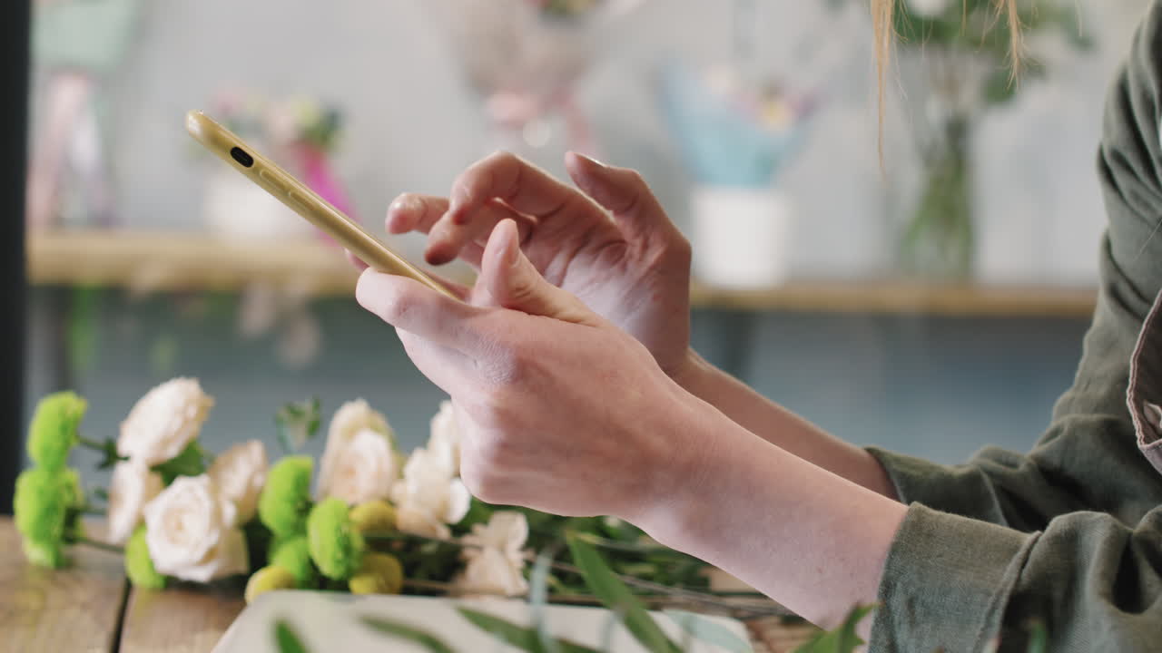Unrecognizable Florist Scrolling Feed At Work