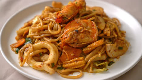 stir fried tom yum seafood dried spaghetti - fusion food style