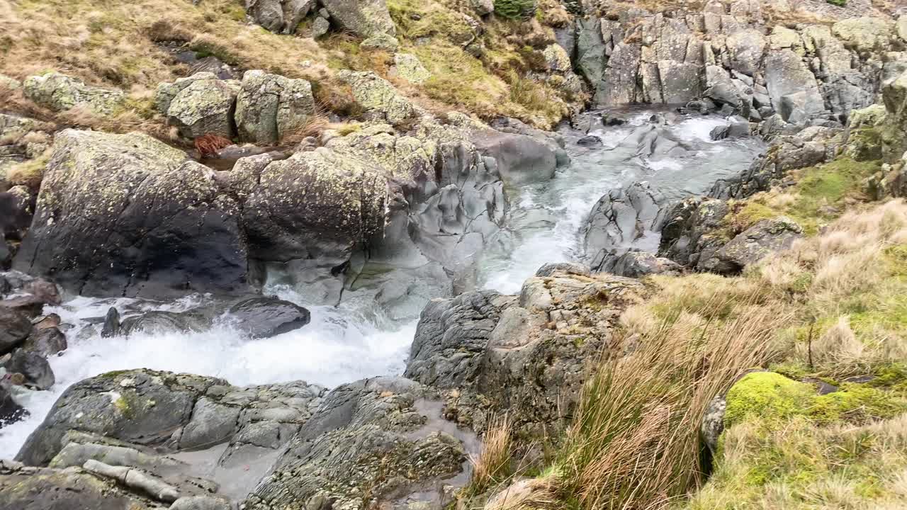 Heavy flowing clear water stream during winter in Lake District - Cumbria, UK