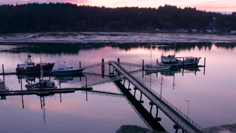 Drone-ascending-over-commercial-fishing-boats-docked-in-Charleston,-Oregon,-which-is-located-near-Coos-Bay-and-North-Bend-at-the-Oregon-coast