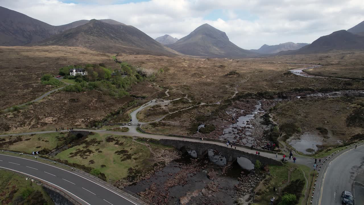 Scenic aerial view of Sligachan Old Bridge with Scottish highlands and river on isle of Skye