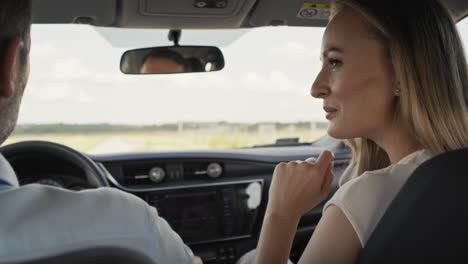 back view of cheerful caucasian of middle age couple during a car trip.