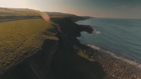 aerial view of lush coastal cliff in scotland - berwick-upon-tweed by the north sea - drone shot