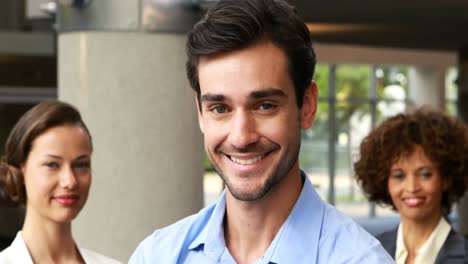 Portrait-of-smiling-executives-standing-with-arms-crossed