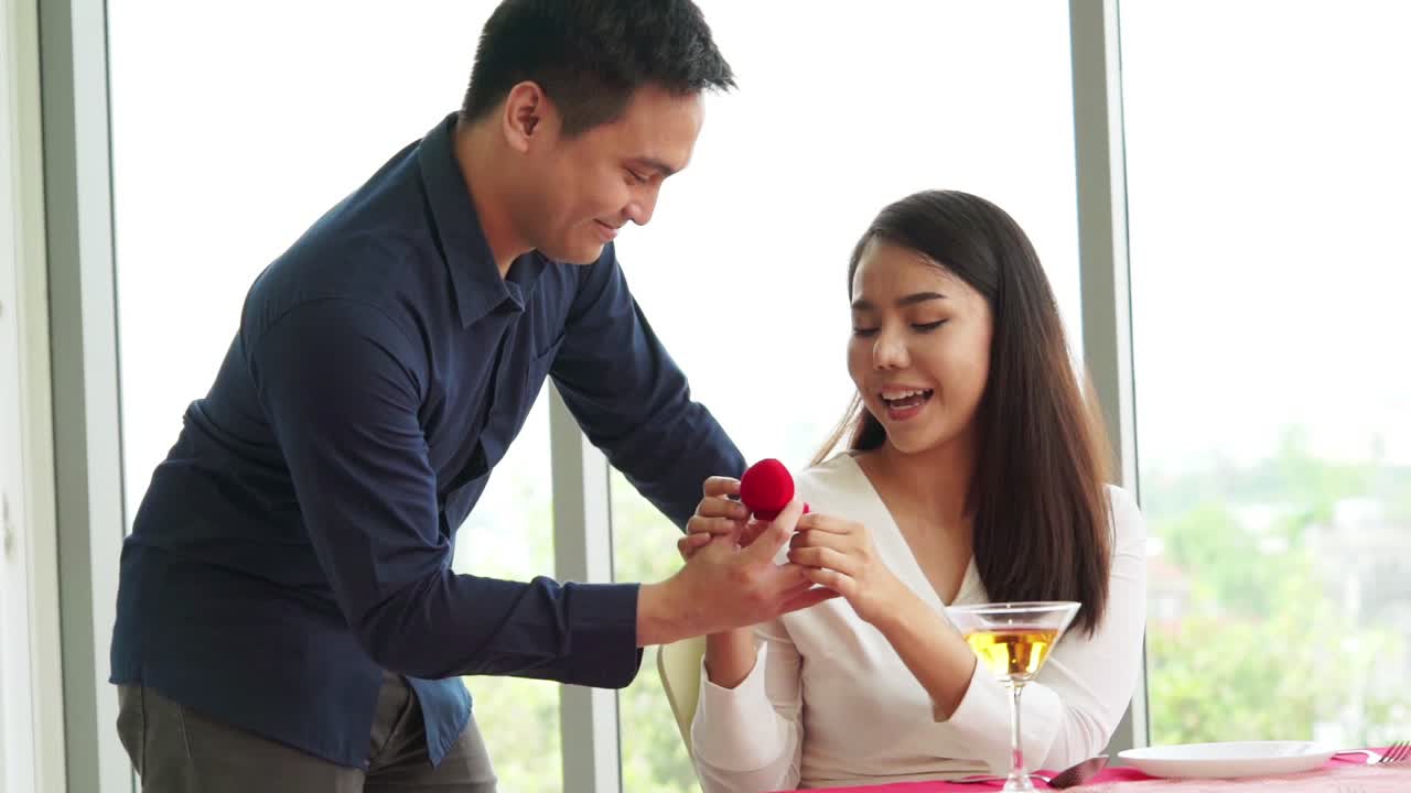 Happy romantic couple eating lunch at restaurant