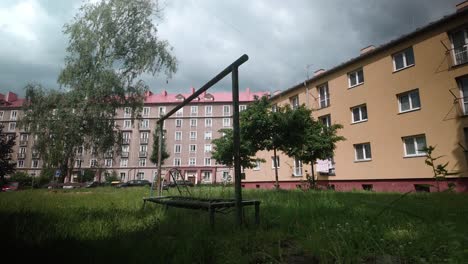 desolate children's playground with soviet-era residential block housing
