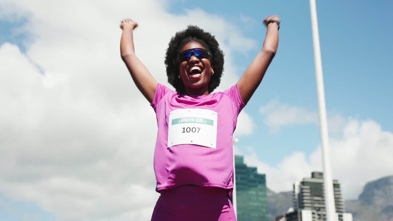 Joyful Woman Athlete Celebrating Success with Arms Raised