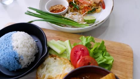 various thai dishes being prepared and served