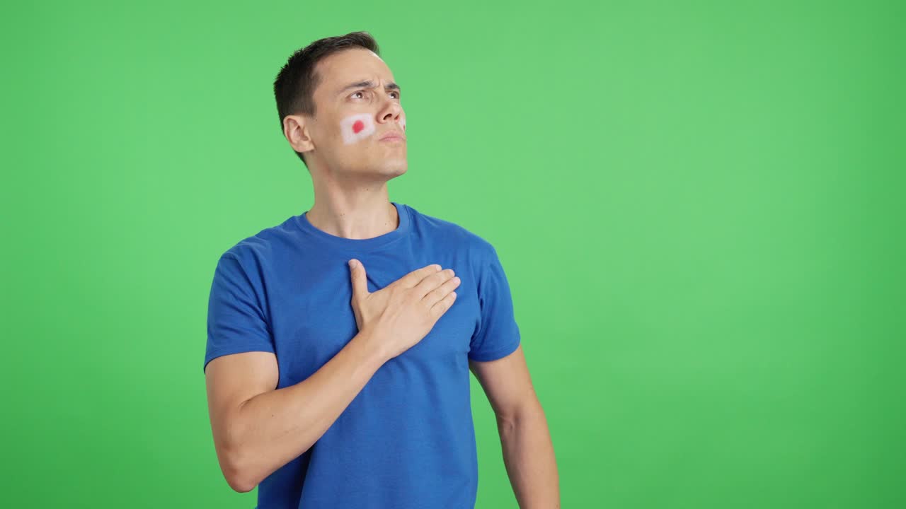 Man listening to the Japan national anthem with solemnity