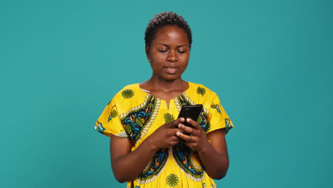 Native-girl-in-ethnic-outfit-browsing-internet-webpages-in-studio