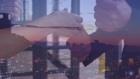 Animation-of-businessman-handshake-over-cityscape