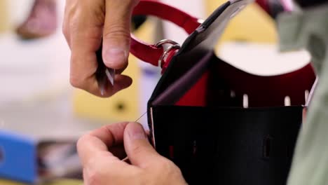 Italian-shoemaker,-making-leather-bag-with-traditional-machines