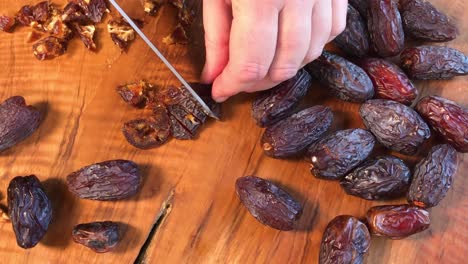 chopping dried medjool dates on cutting board flat lay