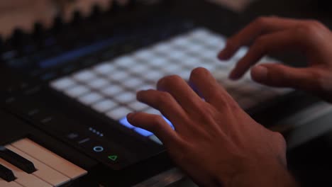 DJ-is-playing-music-on-the-AKAI-MPK-Music-production-hardware,-Slow-motion-close-up