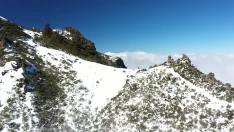 Fast-drone-shot-flying-to-the-edge-of-the-mountain-Pico-Ruivo-in-Madeira