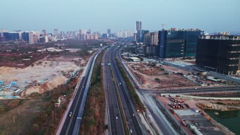 orr with service road, cycle track and commercial buildings at day time, semi circle, drone shot, 4k.
