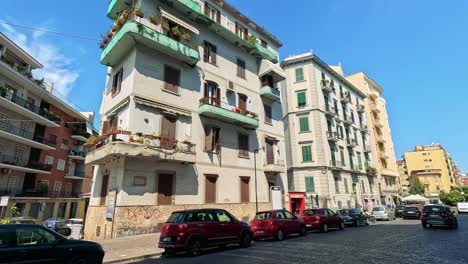 cars and buildings in a sunny naples street