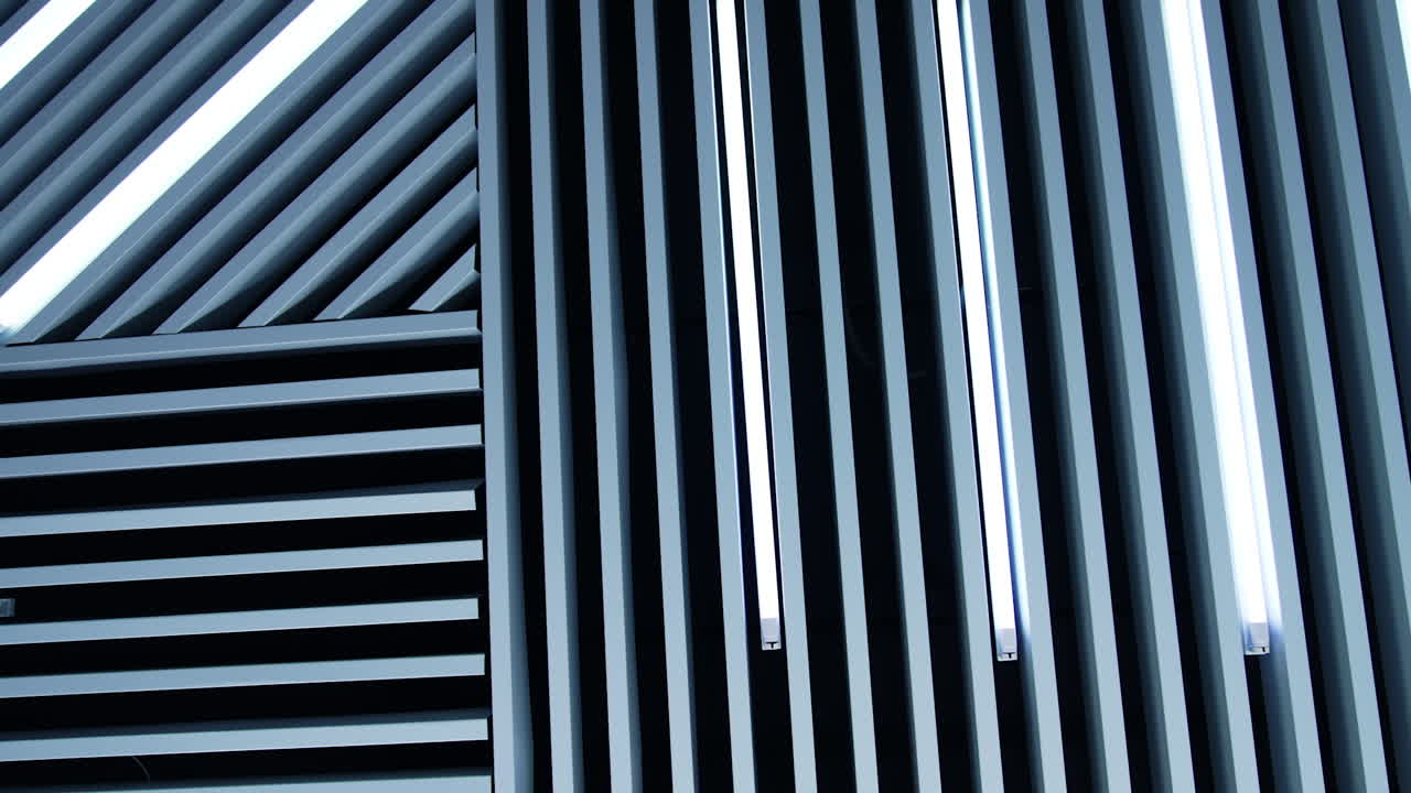 Long white panels decorating the room. Lamps of daylight are a detail of room design.