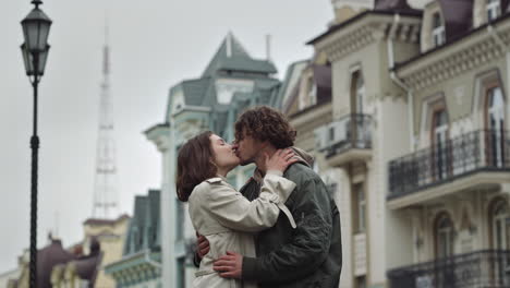 happy couple kissing on urban street