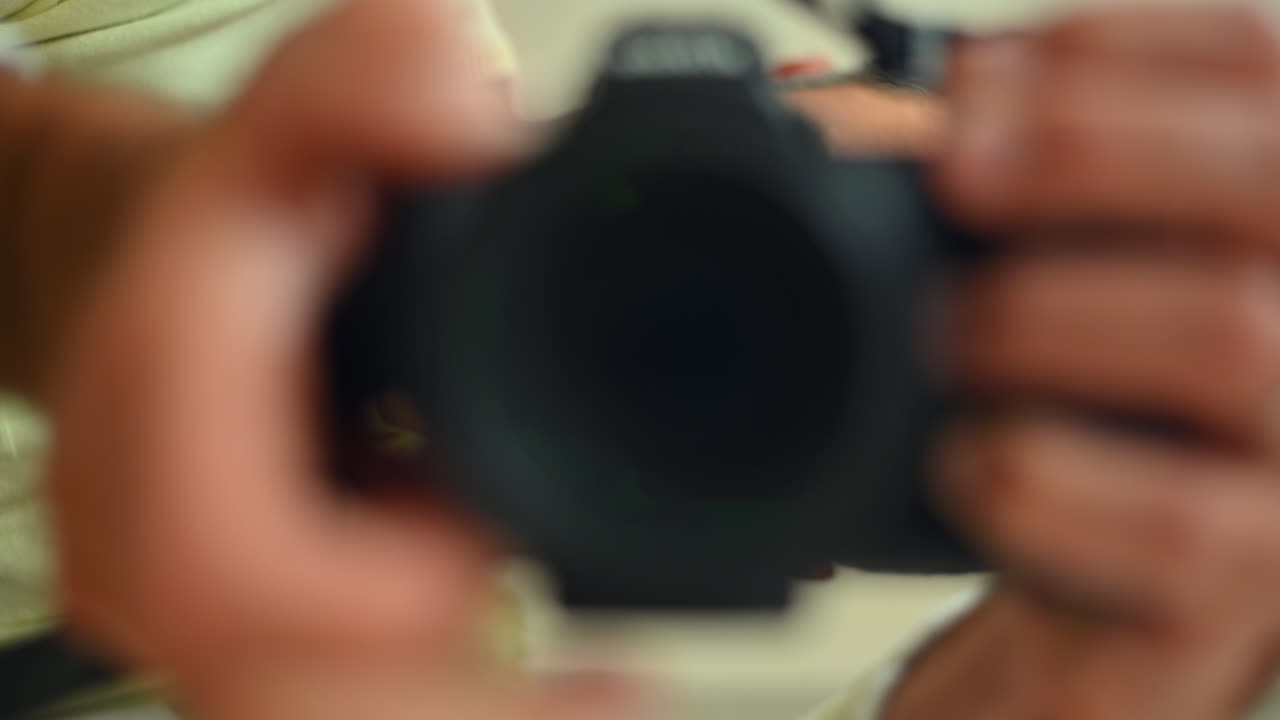 Chisinau, Moldova - January 3, 2022: A person holds a camera, preparing to take pictures in a vibrant environment filled with colorful details. The excitement builds as the lens focuses on the scene ahead