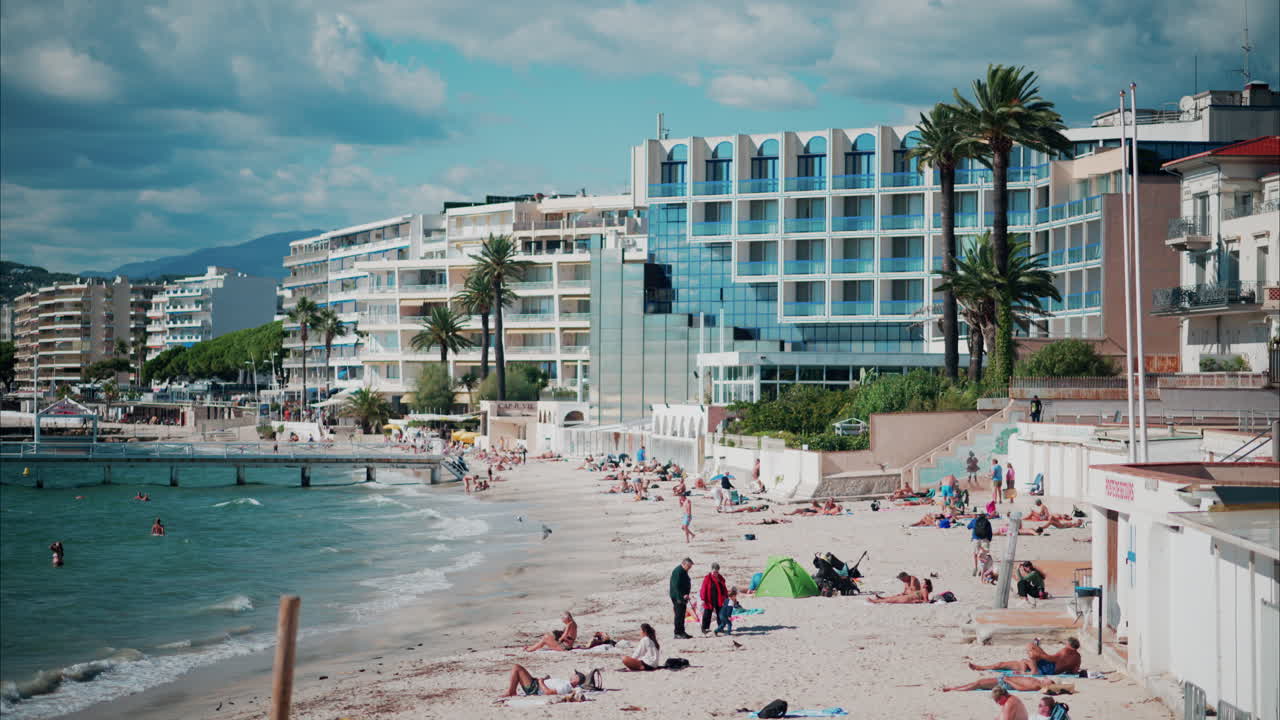 Antibes, France - 20 July, 2024: People swimming in the sea and relaxing on the beach