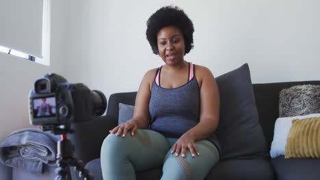 african american female plus size vlogger recording a video about working out