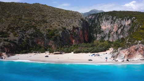 breathtaking aerial view over turquoise gjipe beach and its calcareous rocky cliffs in albanian riviera, europe