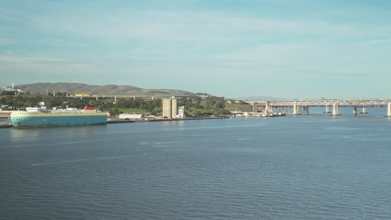 Aerial drone view showcasing the Benicia-Martinez Bridge, with the scenic Benicia shoreline creating a picturesque backdrop.