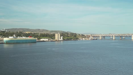 aerial drone view showcasing the benicia-martinez bridge, with the scenic benicia shoreline creating a picturesque backdrop.
