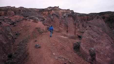 Tourist-Surrounded-By-Tuff-Formations-In-Devrent-Imaginary-Valley-In-Cappadocia